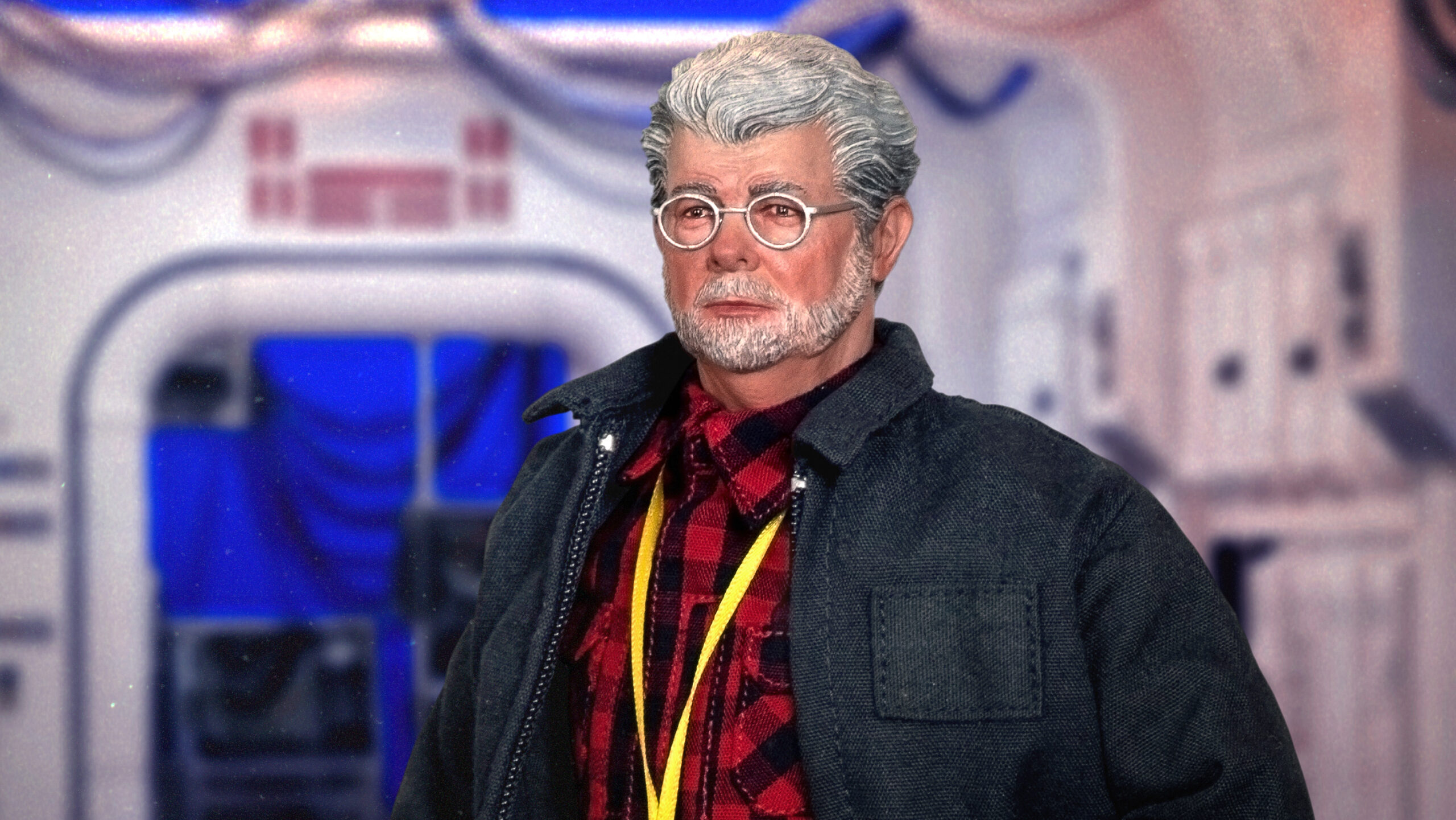 George Lucas 1:6 scale action figure fully dressed with plaid shirt, jacket, jeans, sneakers, and director accessories including coffee cup, headset, and production badge, displayed on custom stand.